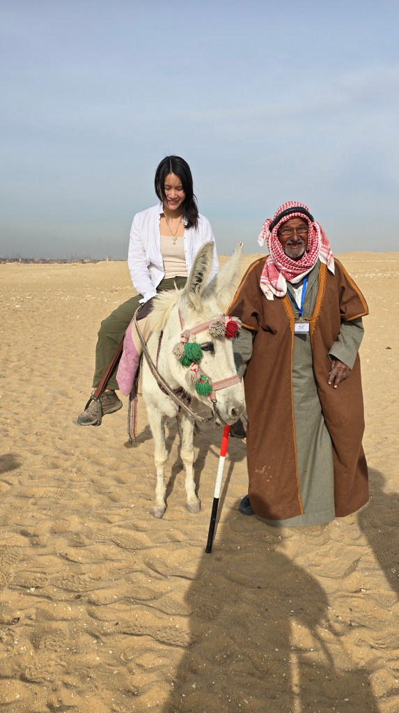 Riding a donkey outside the Serapeum at Saqqara. 