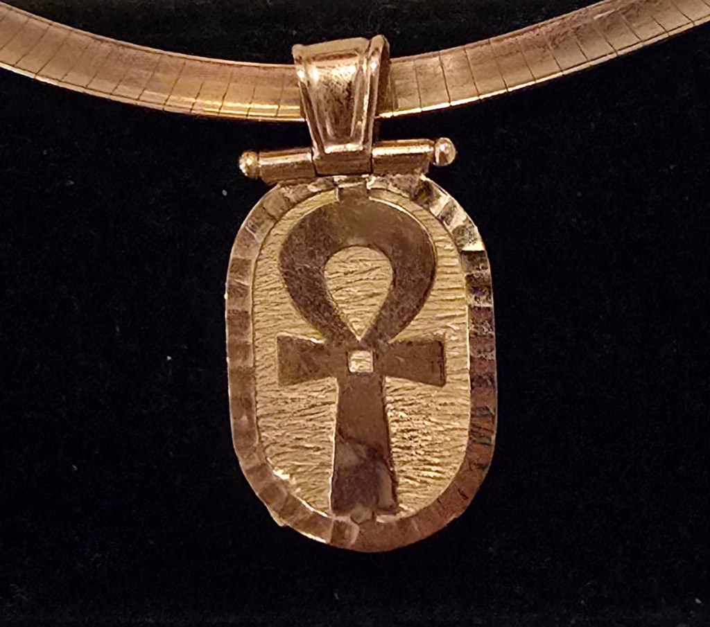 Back of an Egyptian scarab pendant depicting the ankh